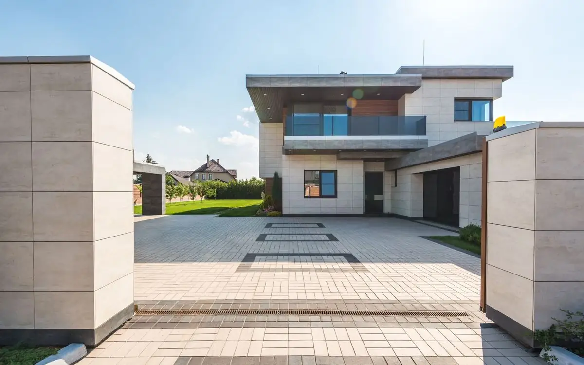 A contemporary home with a wide, neatly paved entrance