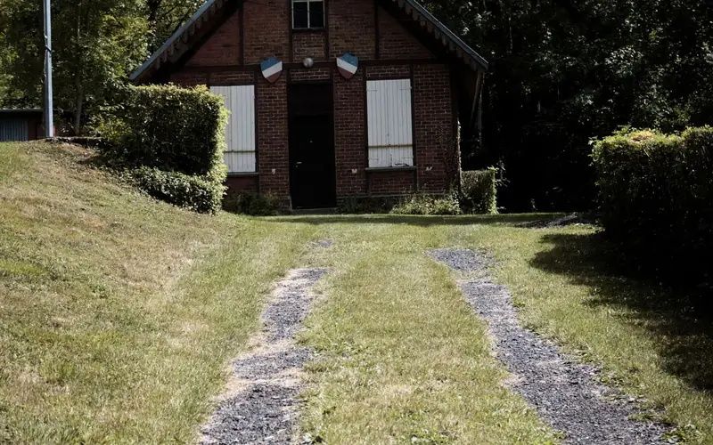 A gravel driveway edged with paving